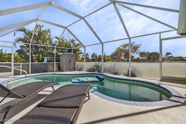 view of swimming pool featuring glass enclosure and a patio area