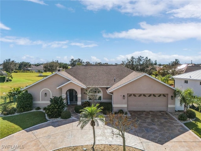 7417 S Blue Sage, Punta Gorda, FL 33955 - view of front facade featuring stucco siding, an attached garage, a front lawn, and driveway