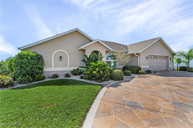 ranch-style house featuring a front lawn and a garage