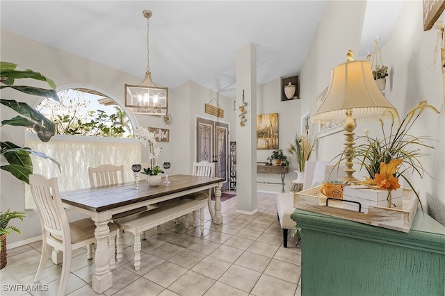 tiled dining room with french doors and a notable chandelier