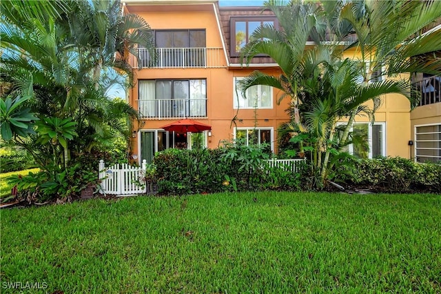 rear view of house with a lawn