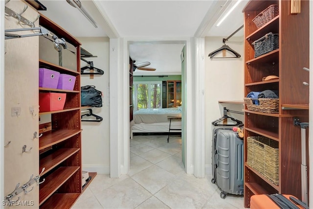 spacious closet featuring light tile patterned flooring and ceiling fan