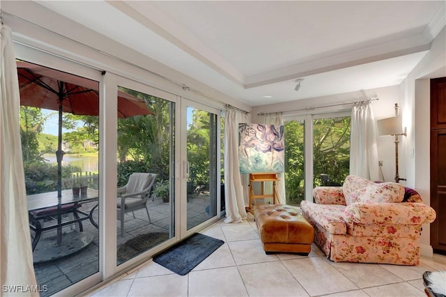 sunroom / solarium with plenty of natural light and a water view