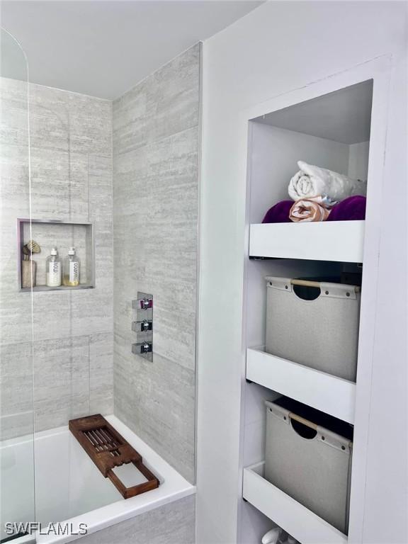 bathroom with tiled shower