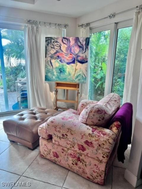 living area featuring a healthy amount of sunlight and tile patterned flooring