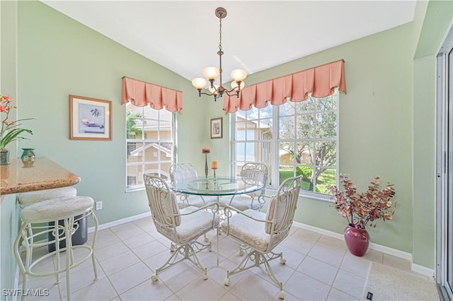 tiled dining room featuring vaulted ceiling and a notable chandelier