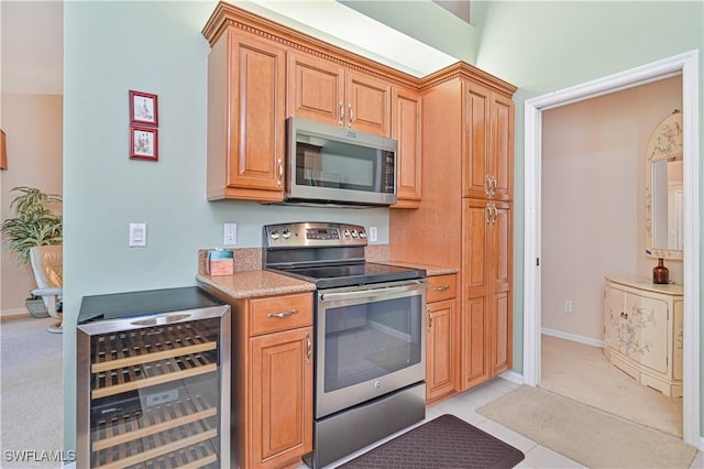 kitchen featuring wine cooler, light colored carpet, and appliances with stainless steel finishes