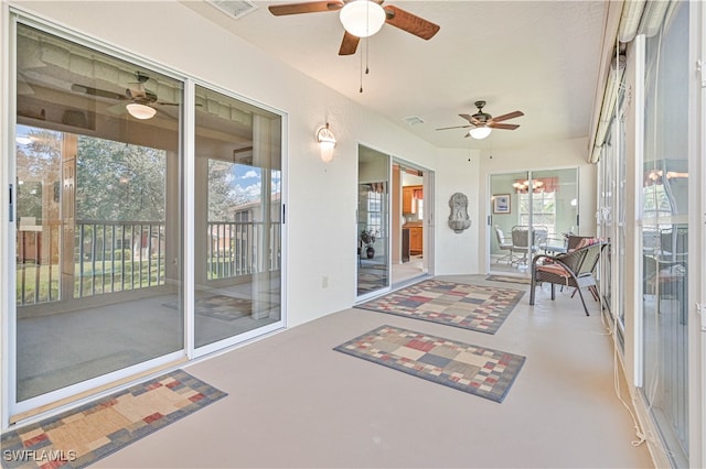 sunroom featuring a notable chandelier and plenty of natural light