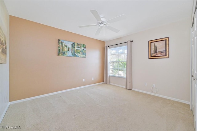 carpeted empty room featuring ceiling fan