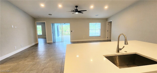 kitchen with tile patterned flooring, ceiling fan, and sink