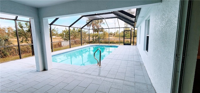 view of pool featuring a patio and glass enclosure