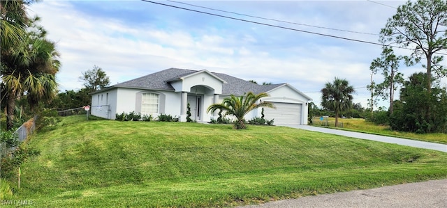 view of front of home with a front lawn and a garage