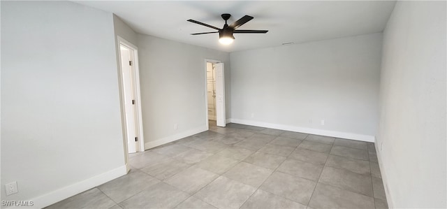 unfurnished room with ceiling fan and light tile patterned flooring