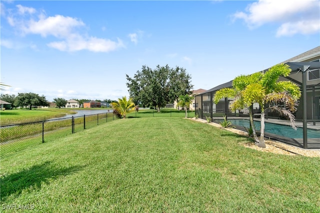 view of yard featuring a fenced in pool and a lanai