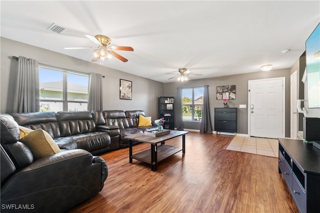 living room featuring ceiling fan and hardwood / wood-style floors