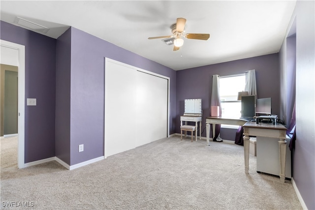 unfurnished office featuring ceiling fan and light carpet