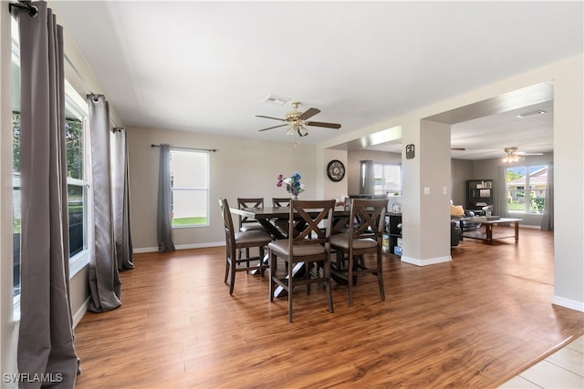 dining room with hardwood / wood-style flooring and ceiling fan