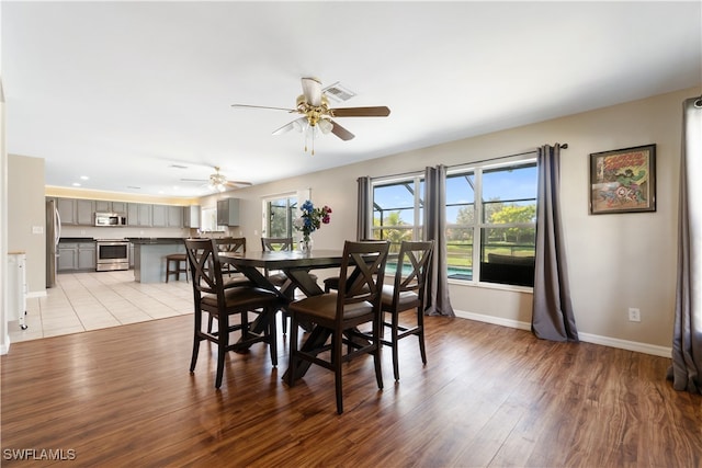 dining area featuring light hardwood / wood-style flooring and ceiling fan