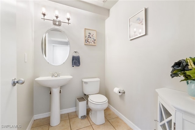 bathroom with toilet and tile patterned flooring