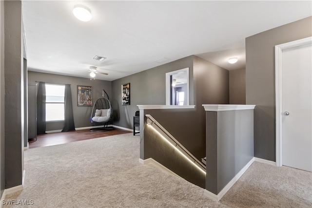 hall featuring dark colored carpet