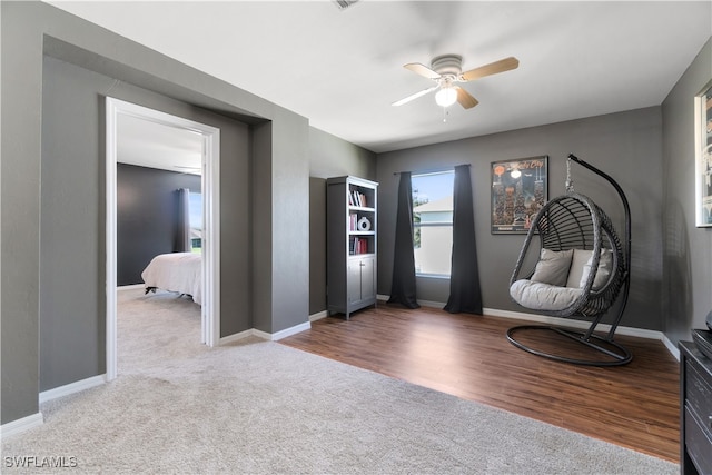 sitting room with ceiling fan and carpet floors