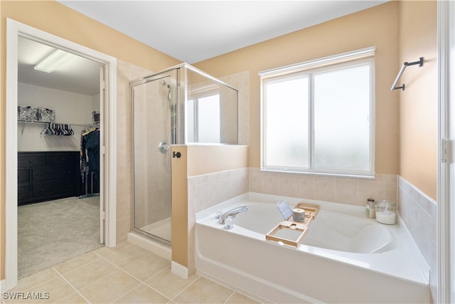 bathroom with tile patterned floors and separate shower and tub