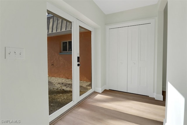 doorway with light wood-type flooring