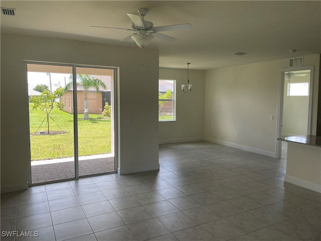 tiled spare room featuring ceiling fan