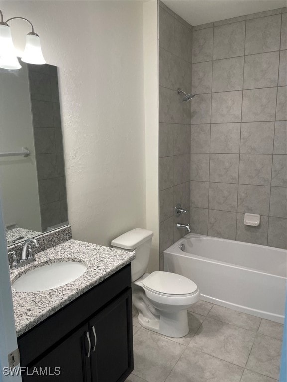 full bathroom featuring vanity, tiled shower / bath combo, toilet, and tile patterned floors