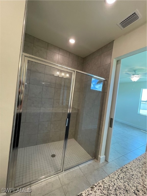 bathroom featuring walk in shower and tile patterned flooring