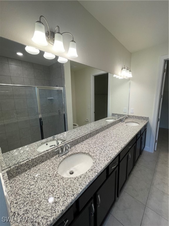 bathroom featuring vanity, an enclosed shower, and toilet