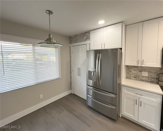 kitchen with white cabinetry, wood-type flooring, stainless steel fridge with ice dispenser, and pendant lighting