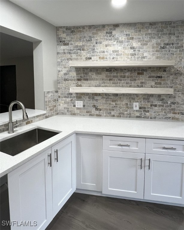 kitchen featuring white cabinetry, tasteful backsplash, sink, and dark wood-type flooring