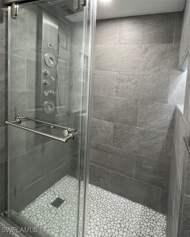 bathroom featuring a shower with door