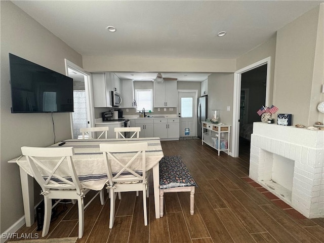 159 Pearl St, Fort Myers Beach, FL 33931 - dining room with baseboards, a ceiling fan, and dark wood finished floors
