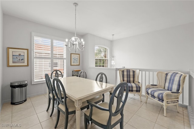 tiled dining room featuring an inviting chandelier