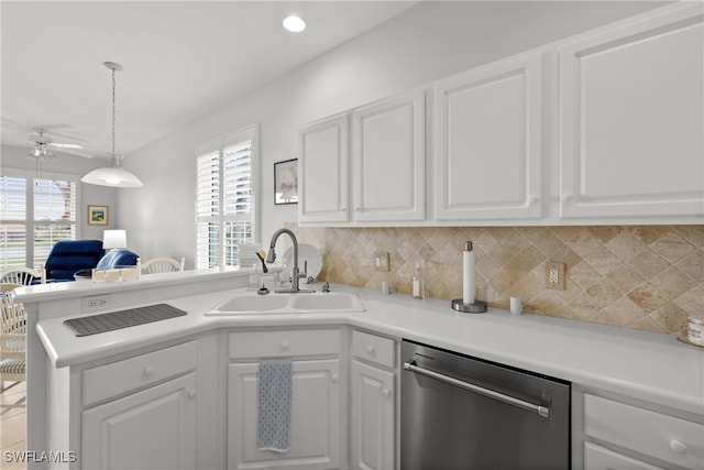 kitchen with a healthy amount of sunlight, sink, stainless steel dishwasher, and white cabinets