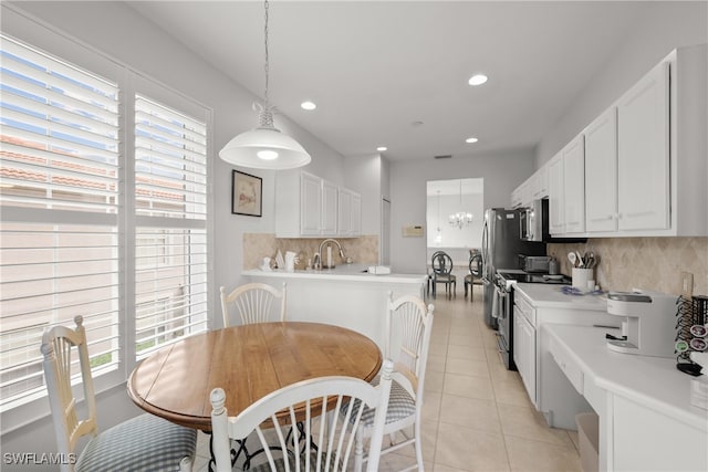 kitchen featuring appliances with stainless steel finishes, a wealth of natural light, and white cabinets