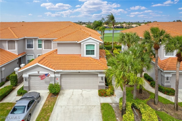 view of front of property with a water view and a garage