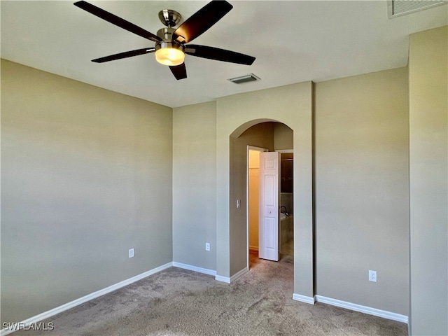 unfurnished room with ceiling fan and light carpet