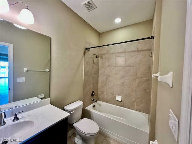 full bathroom featuring tile patterned floors, vanity, tiled shower / bath combo, and toilet