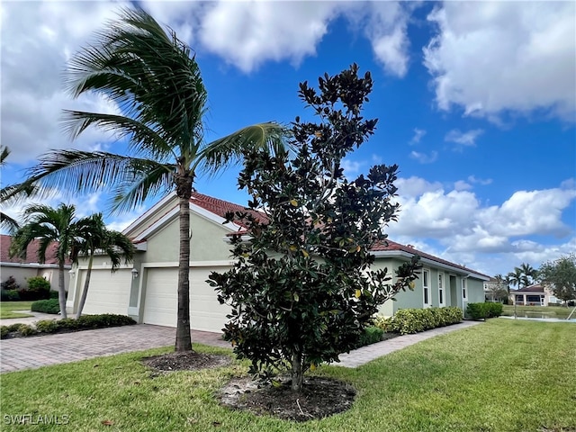 view of property exterior with a yard and a garage