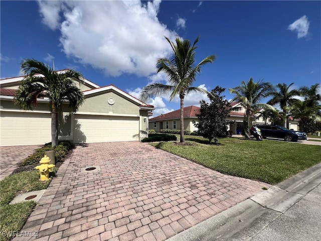 view of front of house featuring a garage and a front lawn