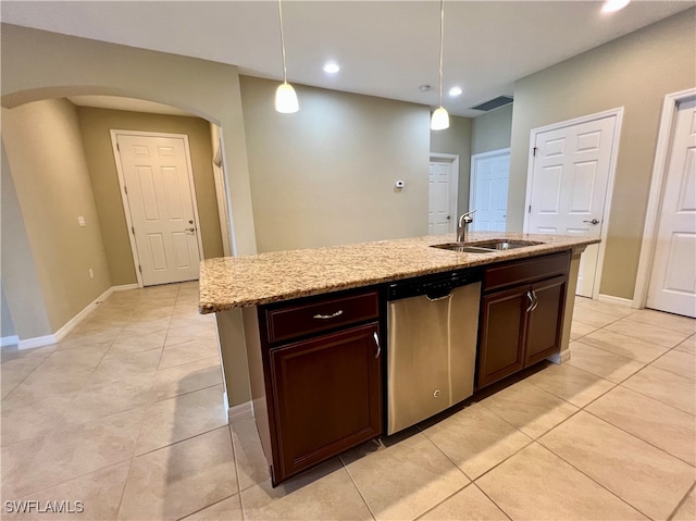 kitchen with dishwasher, hanging light fixtures, a center island with sink, and sink