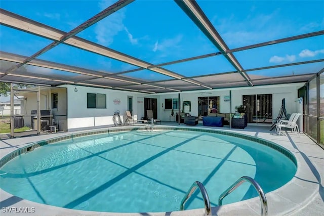 view of swimming pool featuring a patio, a lanai, and outdoor lounge area