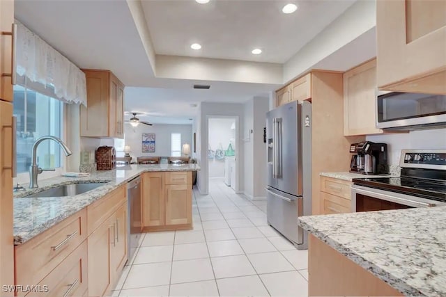 kitchen featuring sink, appliances with stainless steel finishes, and light brown cabinets