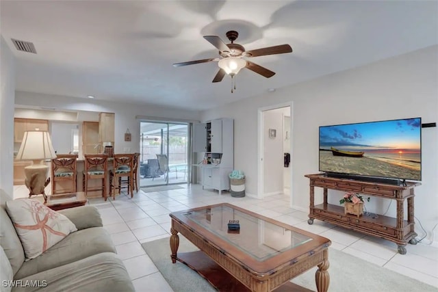 tiled living room featuring ceiling fan