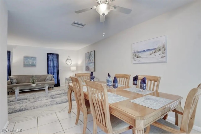 tiled dining area featuring ceiling fan