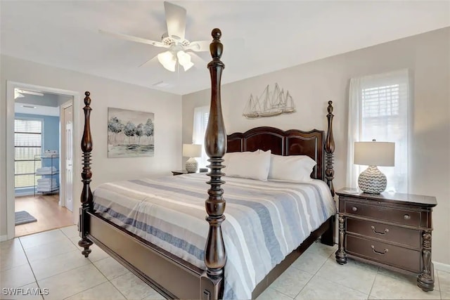 bedroom with multiple windows, light tile patterned floors, and ceiling fan