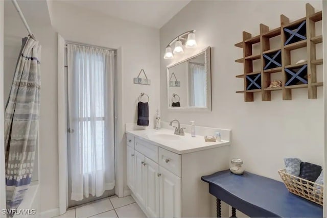 bathroom featuring vanity, shower / bath combo, a healthy amount of sunlight, and tile patterned floors